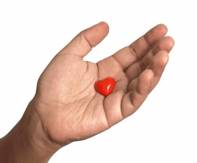 Hand holding heart-shaped candy
