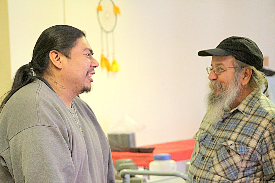 Two men talking at Senior Meals