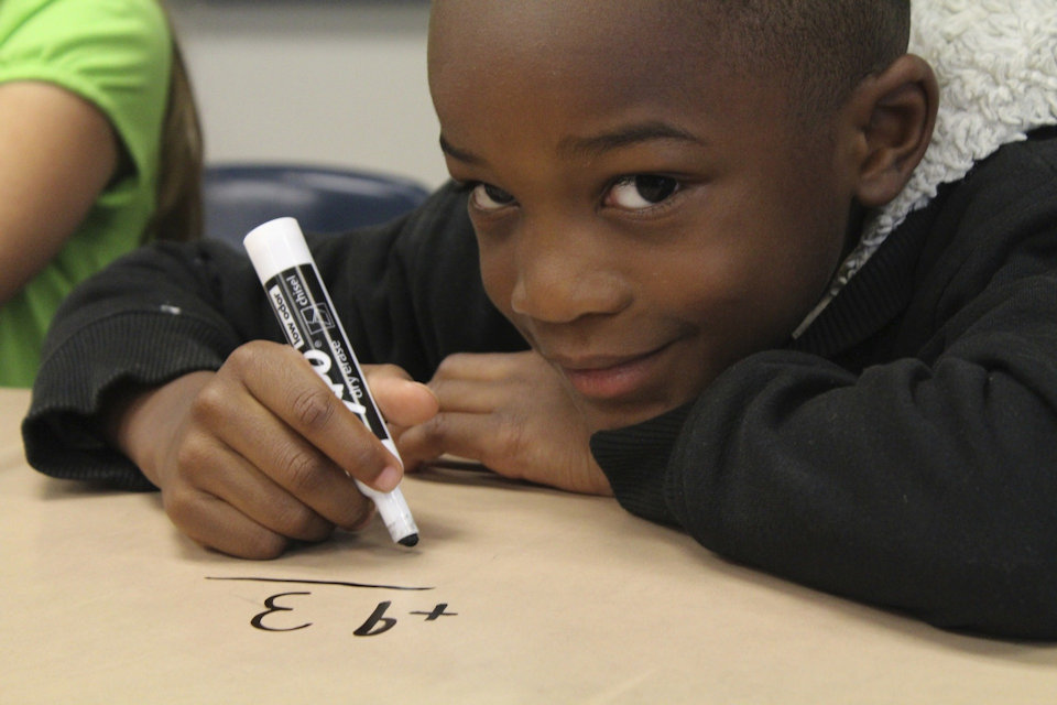 Child at school doing math