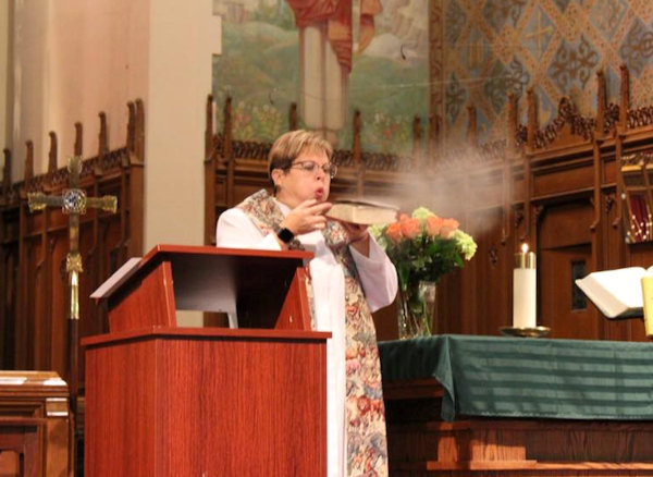 Pastor blows dust off Bible.