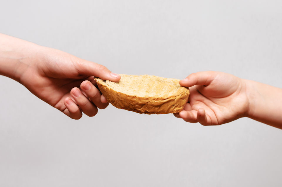 Hand sharing bread