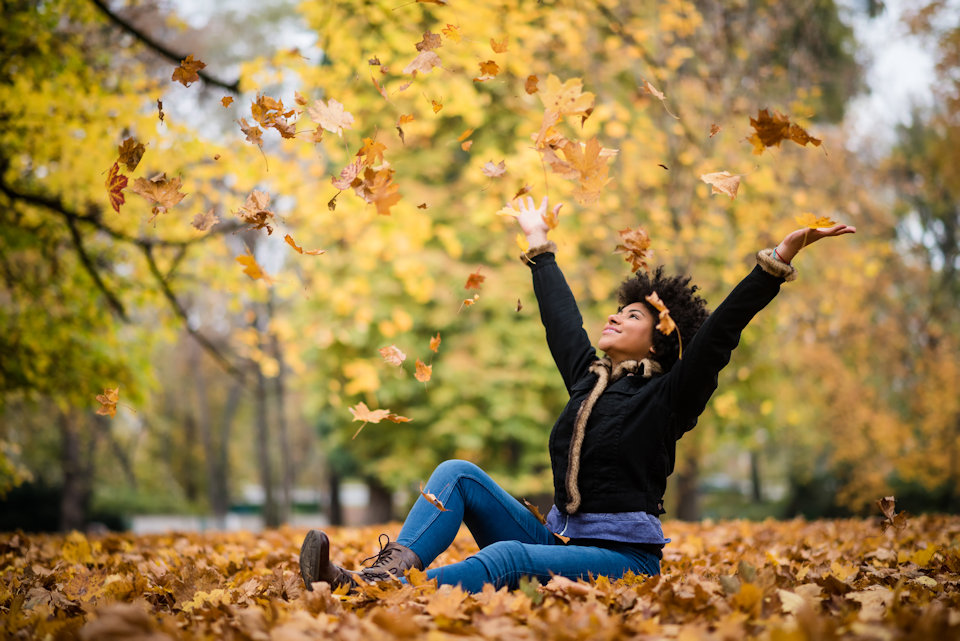 Woman enjoying fall leaves
