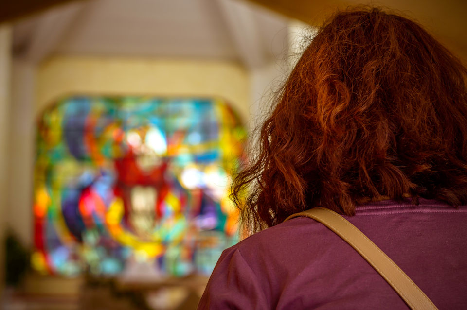 One person sitting in a church sanctuary