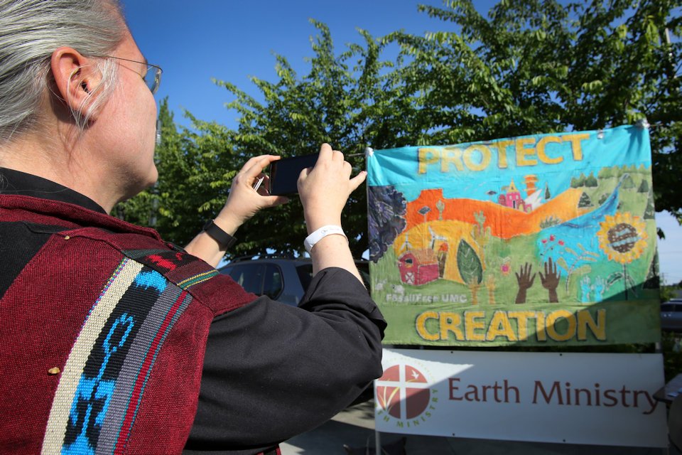 Woman viewing Protect Creation poster