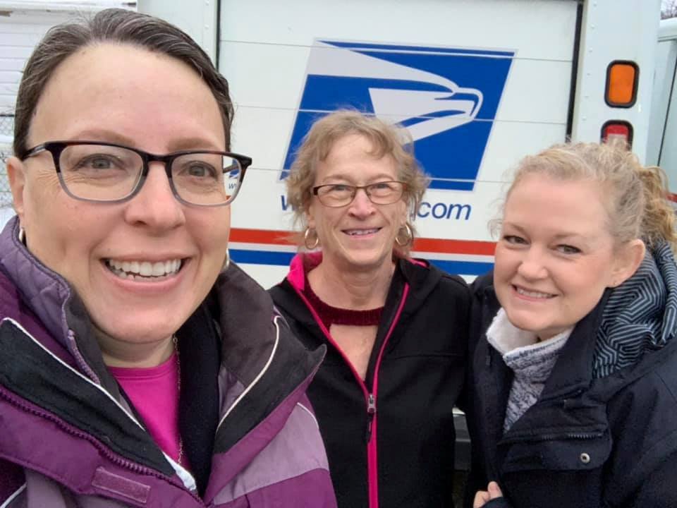 Women delivering goodies to US Postal Service