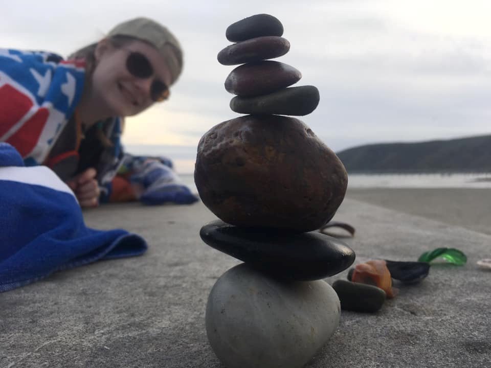 NMU student balancing rocks