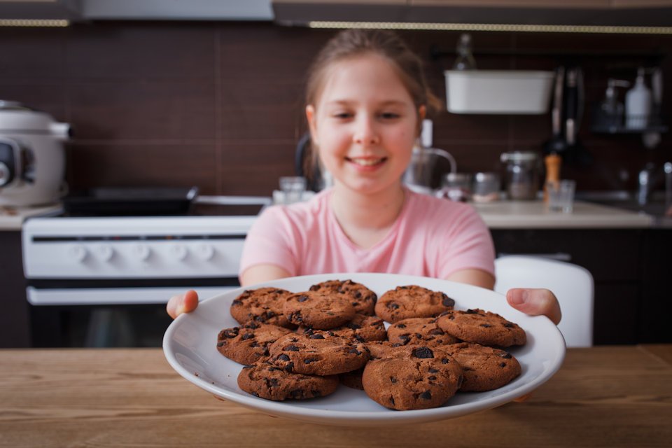 Girl with plate of cookies.