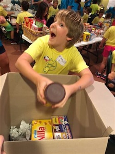 Child fills food box.