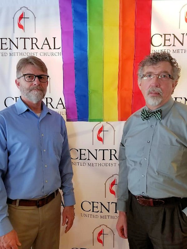 Pastors of Traverse City: Central United Methodist Church stand with rainbow sign of welcome.