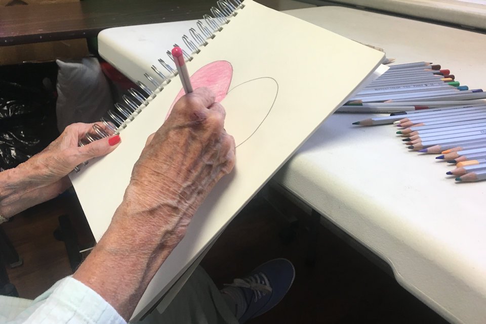 Woman's hands making a drawing