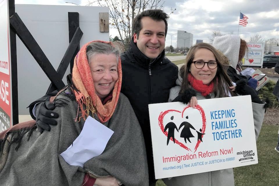 Three people marching for immigration reform