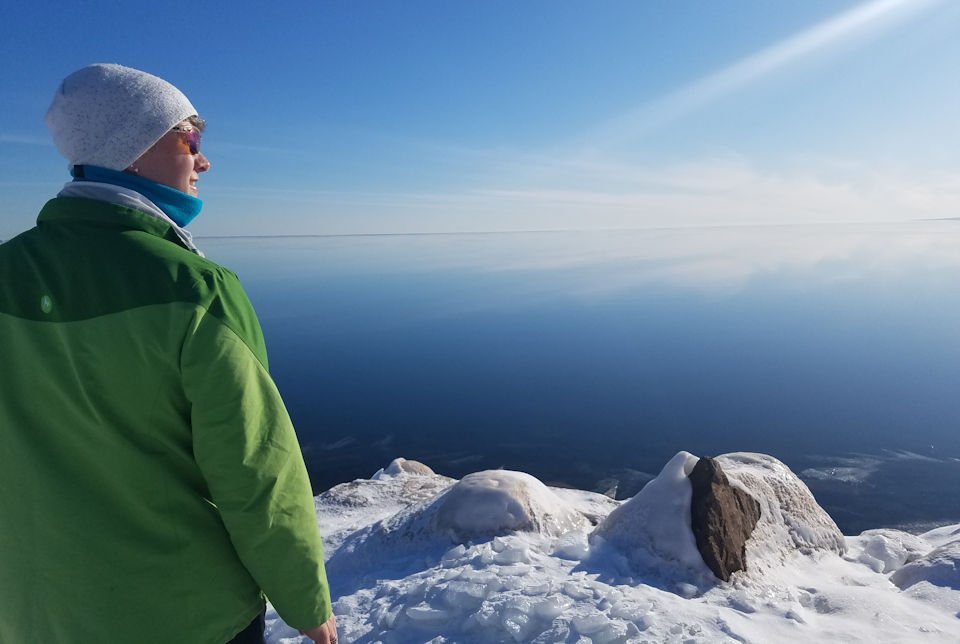 Woman looking over frozen Lake Superior