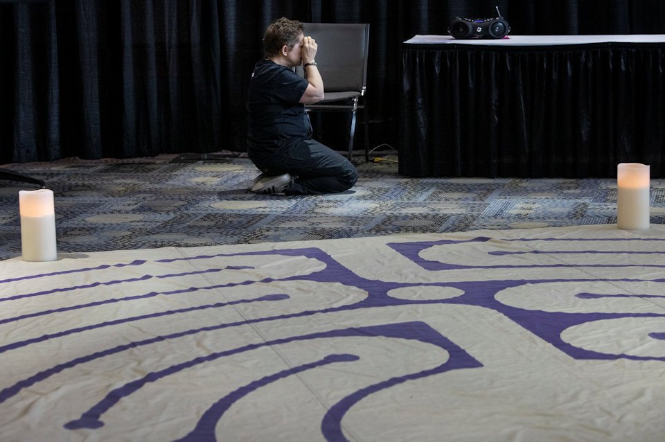 Woman praying at General Conference 2019