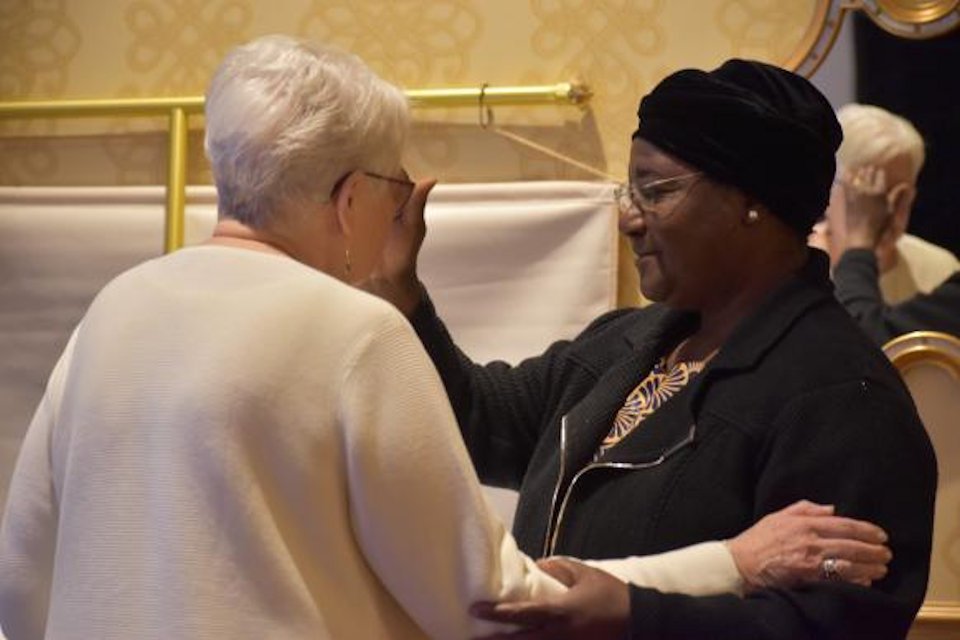 Two women bishops renewing baptism