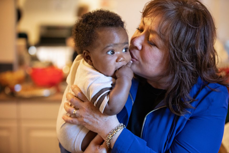 Bishop Minerva Carcano with an immigrant child.