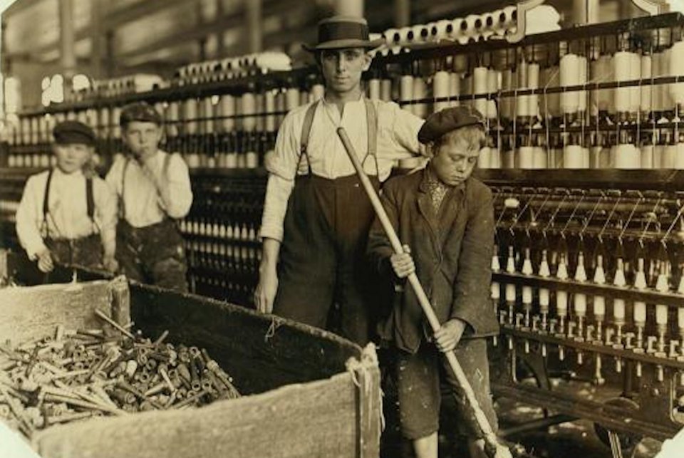 Children laboring in a factory in the early 20th century