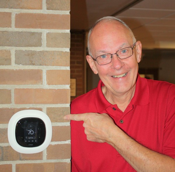 Man pointing at thermostat