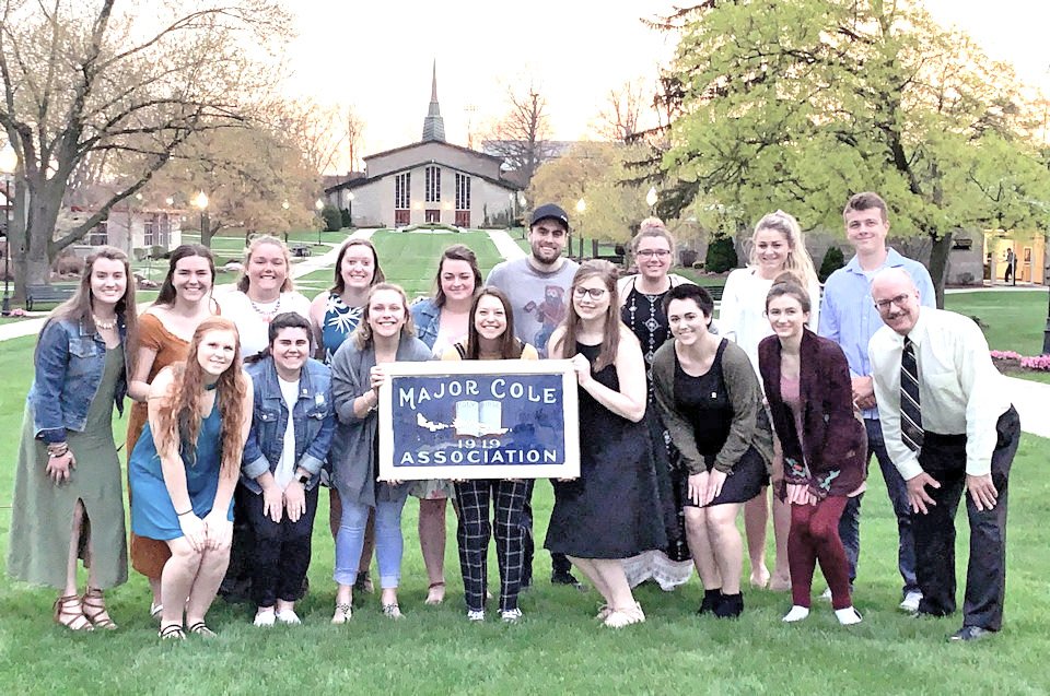 Rev. Chris Momany at students on Adrian College quad