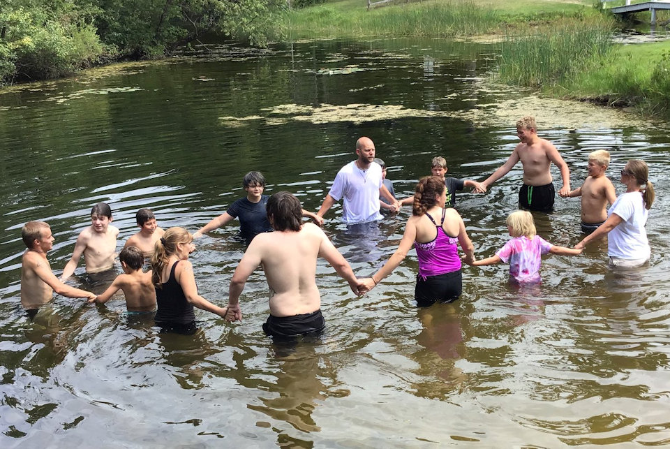 People in river for baptism