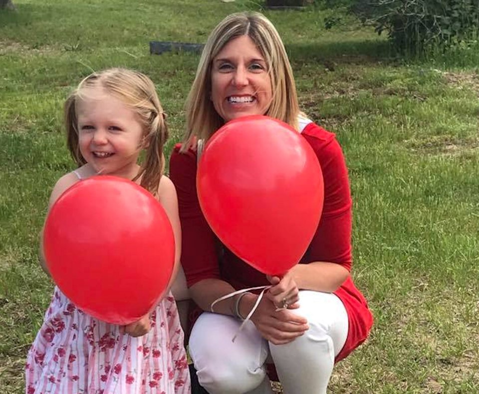 Mother and child with red balloons