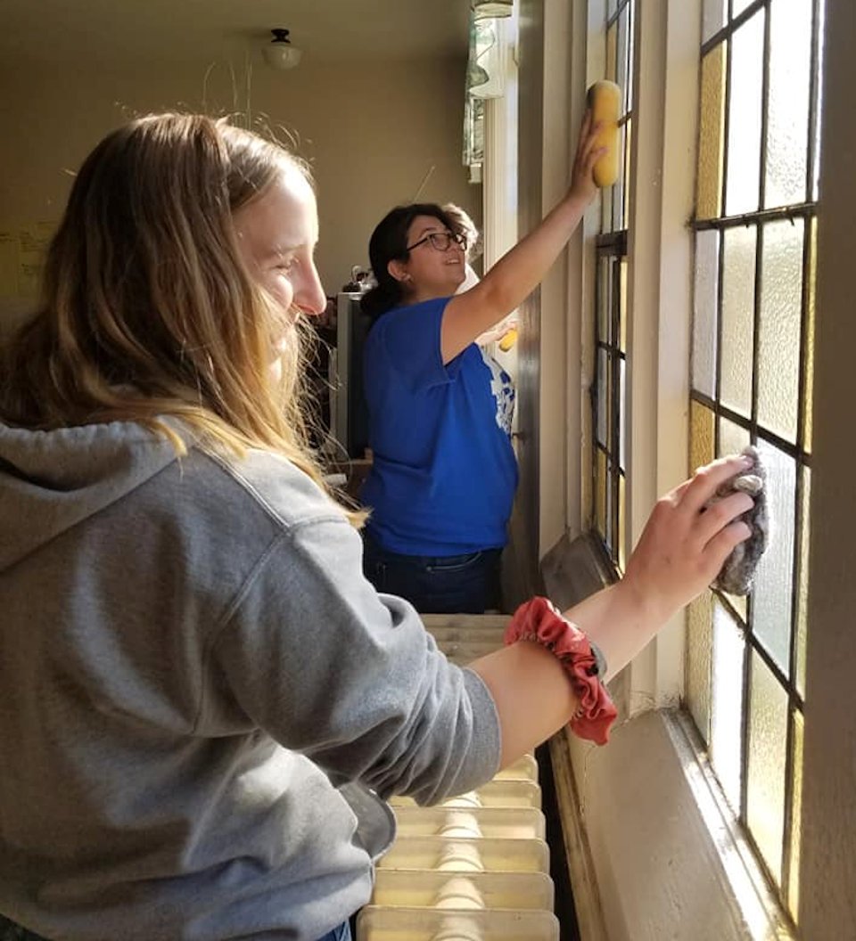 Young women washing windows