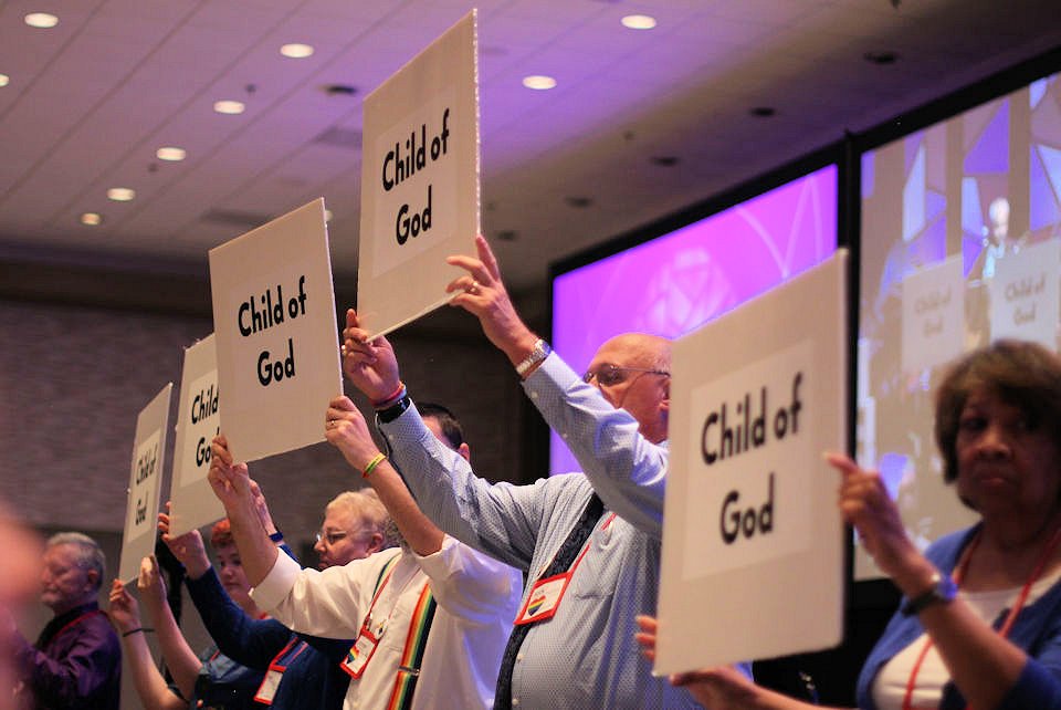Persons holding placards during opening worship