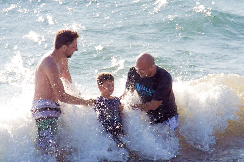 Pastor baptizes child in lake