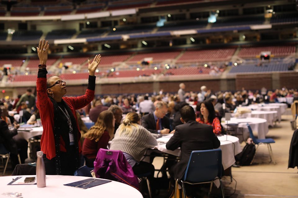 Woman praying at St. Louis General Conference.