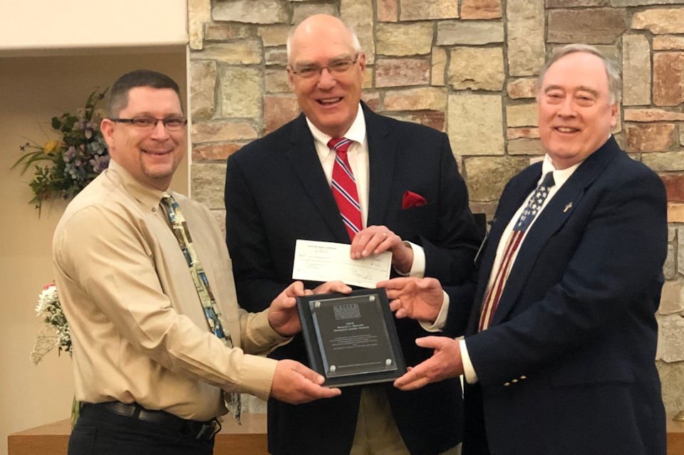 Pastor and Finance Chair Coleman Faith UMC accept Wayne Barrett Award for generous giving.