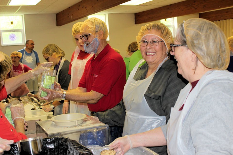 Assembly line to package food for Kids Against Hunger