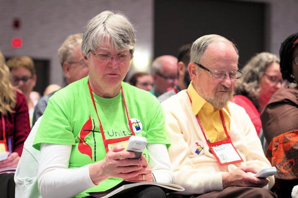 Diana and Duane Miller use electronic voting devices at The Michigan Conference.