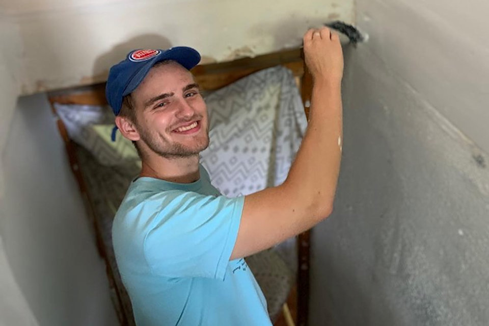 Young man painting during his summer vacation for Appalachia Service Project