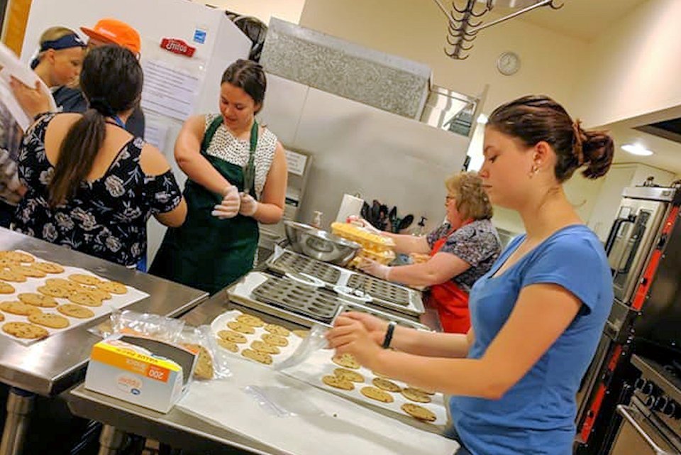 Youth bake cookies for Youth 2019 trip