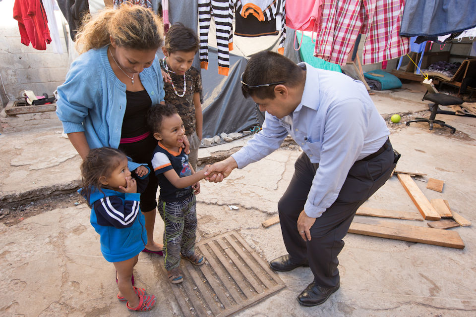 Pastor seeing and greeting children and parents at the border