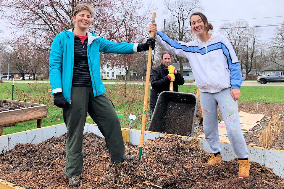 College students work in garden at Sunnyside UMC getting ready for planting.