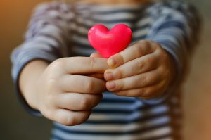 Child holding a heart