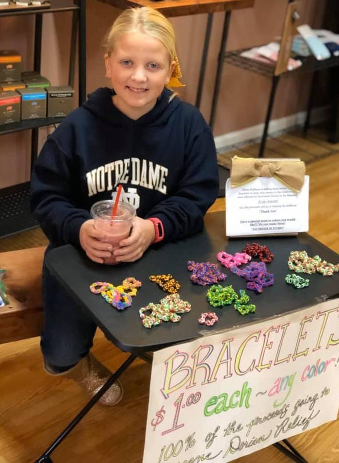 Girl selling bracelets