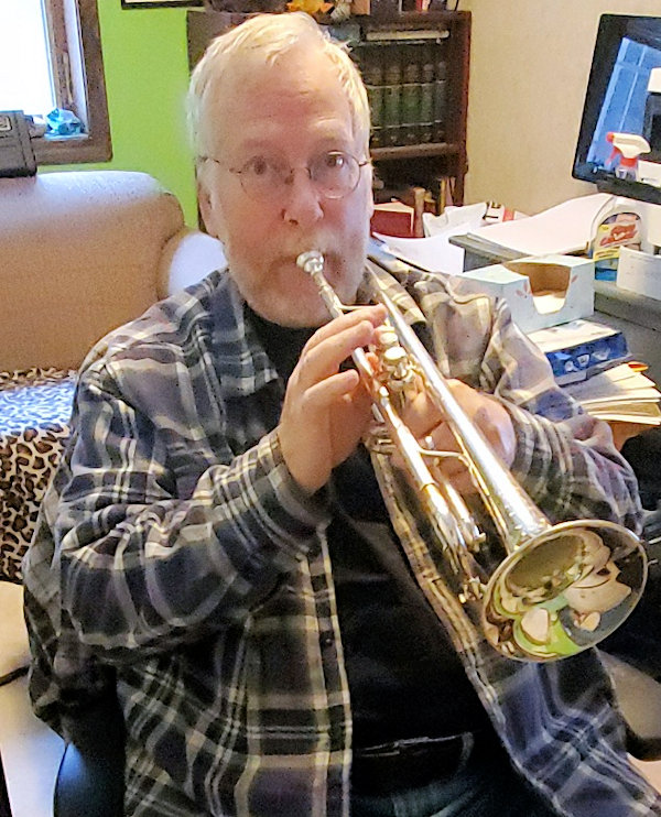 Paul gives a toot on his trumpet