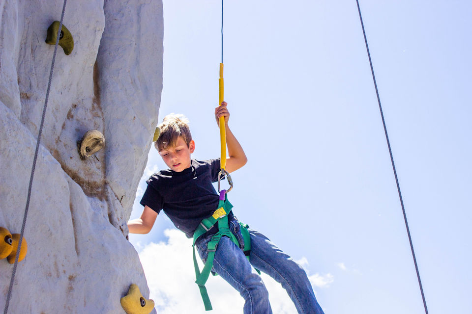 Boy climbing wall at Bay Shore