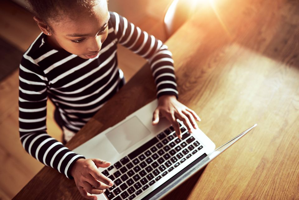 Girl with on of several learning devices