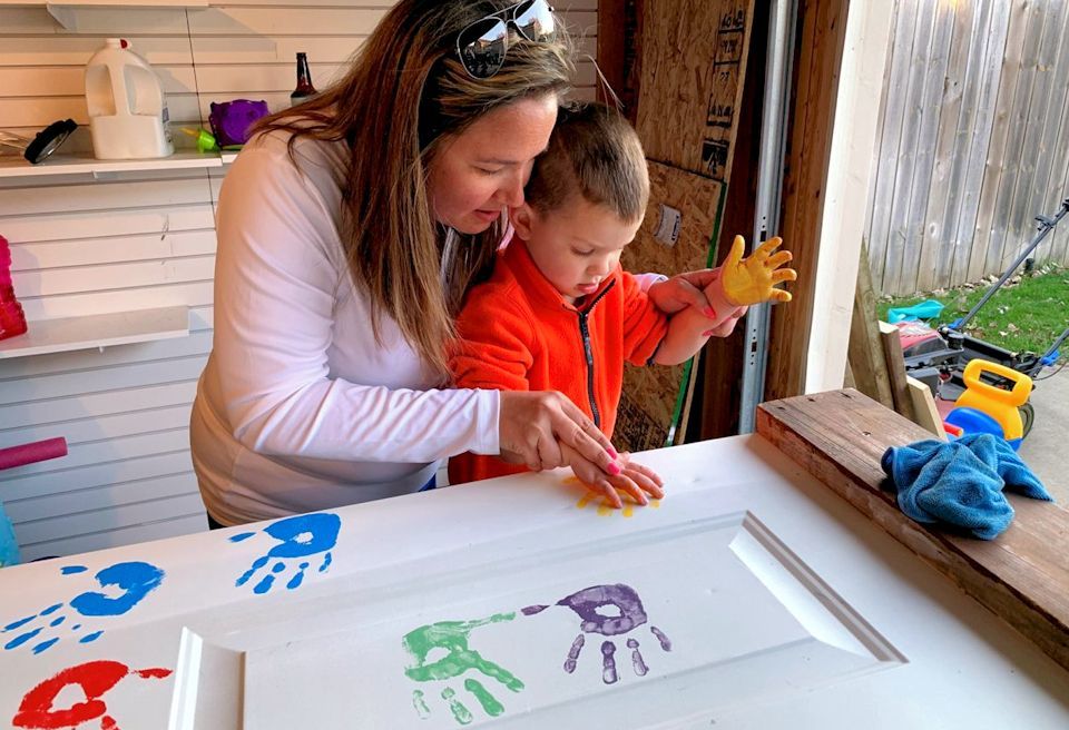 Mom and child painting doors