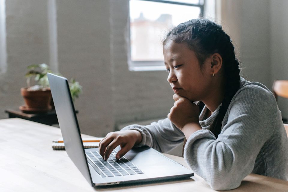 Child at laptop engaging with church without walls.