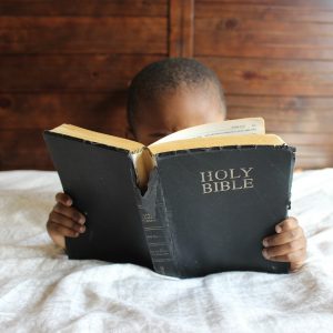 Child reading Bible