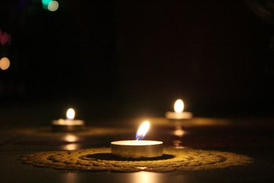 three small candles in a dark room