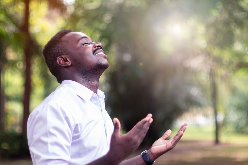 Man giving praise for new day