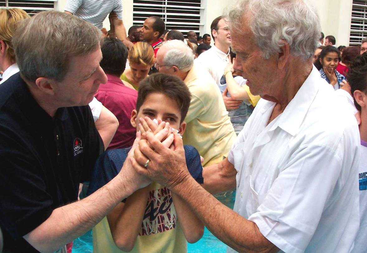 Eddie Fox baptizes young man