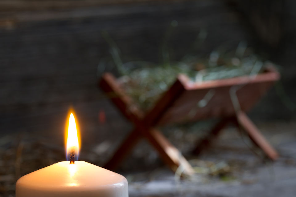 Christmas Candle by a manger