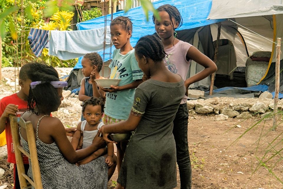 Family hit by earthquake in Haiti. UMCOR grant provided a tent.