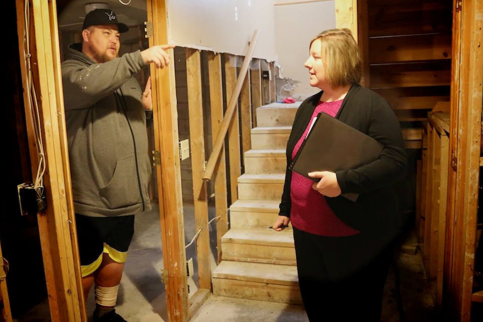 Anne Wortley assists a flood victim in Midland.