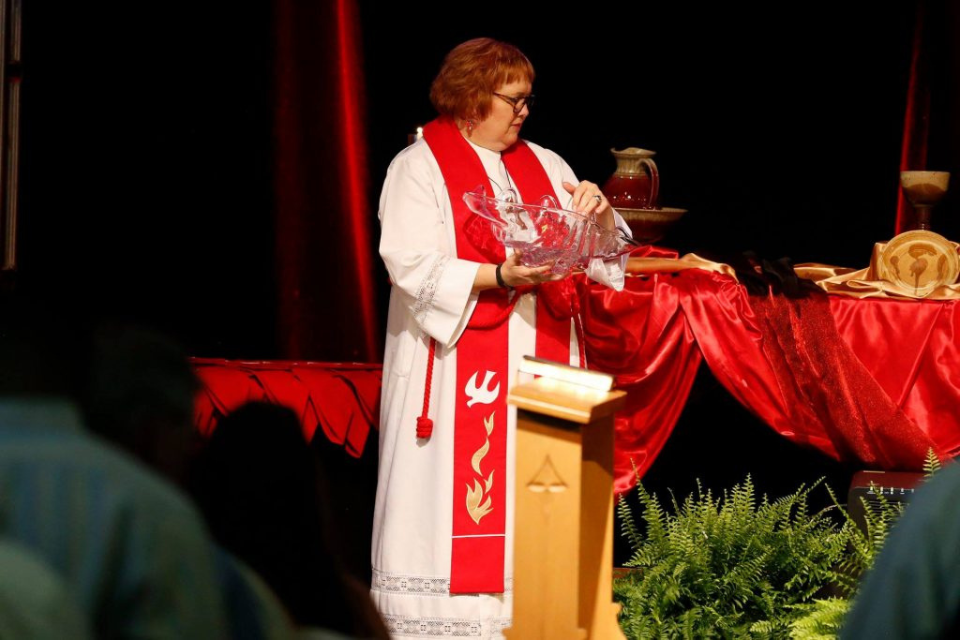 Amy Coles participating in a baptism.